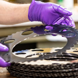 close up of gloved hands with polishing carrier